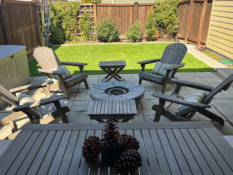 Adirondack Sitting Area with a Firepit and a Fully-fenced Yard.