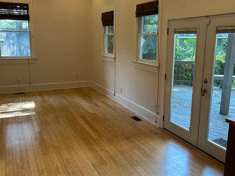 Living Room Looking Out French Doors to Private Back Porch and Off Street Parking