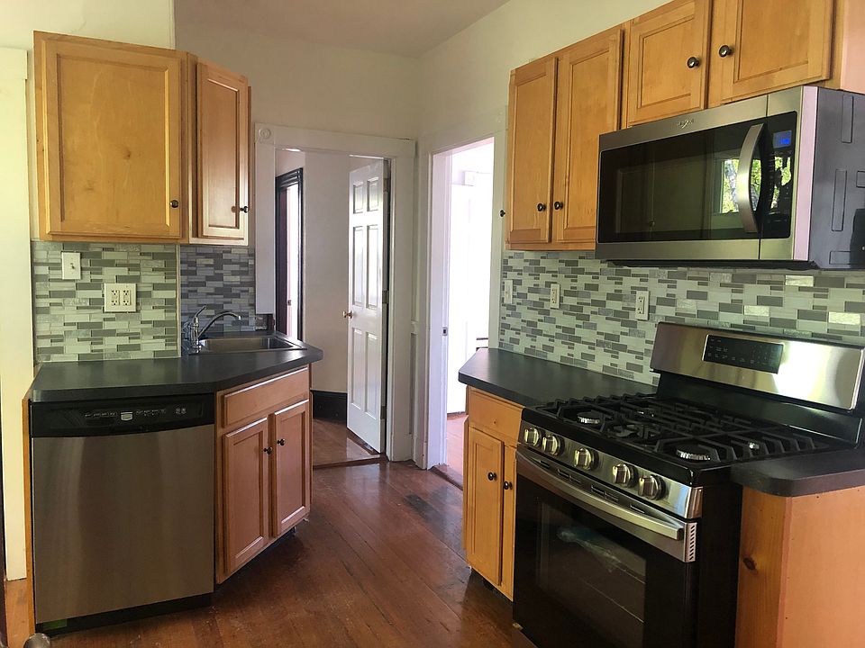 Kitchen with updated appliances and tiled backsplash