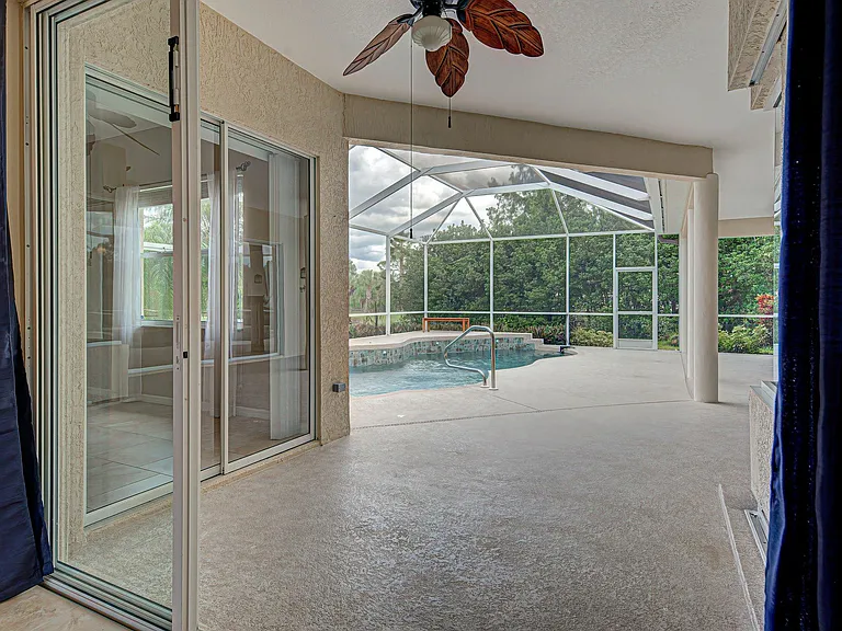 Looking out to lanai and pool from the living room