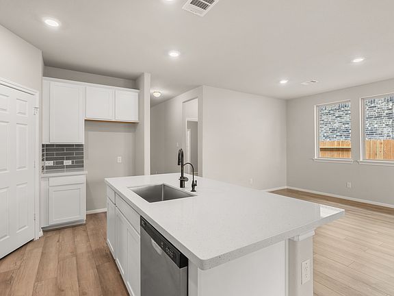 The kitchen has a large center island overlooking the dining area