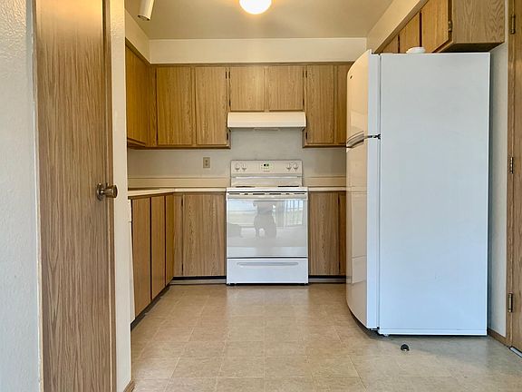 Kitchen with pantry, door lead to attached 1-car garage, with washer/dryer hookup available.