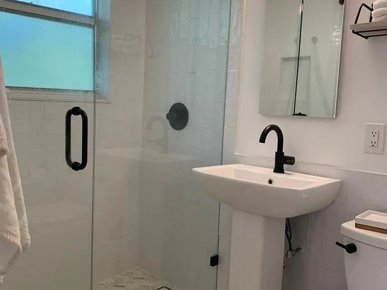 Renovated Bathroom | marble floors, frameless shower door