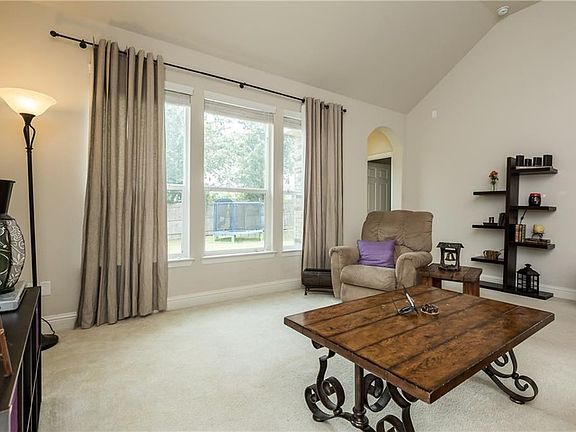 Cozy sun filled family room overlooking large backyard and Greenbelt.