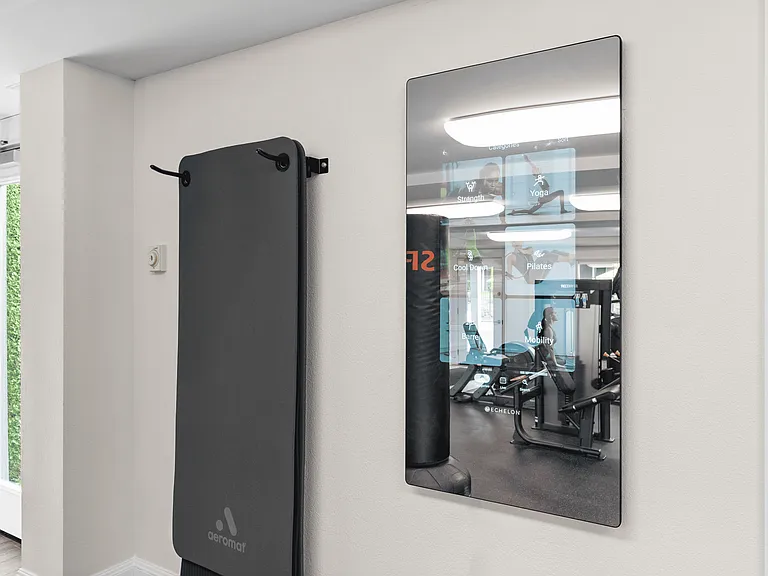 Interactive fitness mirror for guided workouts and training.
