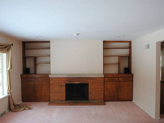 The living room has a gas fireplace and beautiful, large windows to view the private backyard.