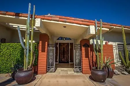 Entry to the house with carved door.