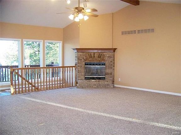 The large vaulted great room has a fireplace for those winter nights and plenty of windows to overlook the lake and scenery.  New carpeting throughout the entire home.