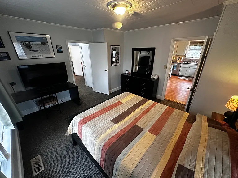 The rear bedroom opens to the kitchen and the middle bedroom. With the door closed, it's a private corner of the house.