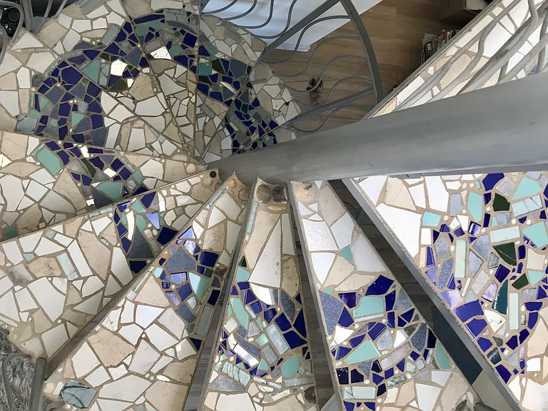 A hand-mosaiced spiral staircase leads you upstairs to the living/dining/kitchen area.