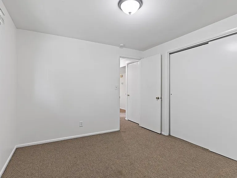 Bedroom with Ample Closet Space
Bath and Utility Closets in Hall