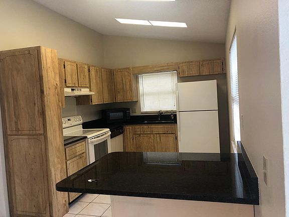Kitchen with oven, microwave, dishwasher and fridge.