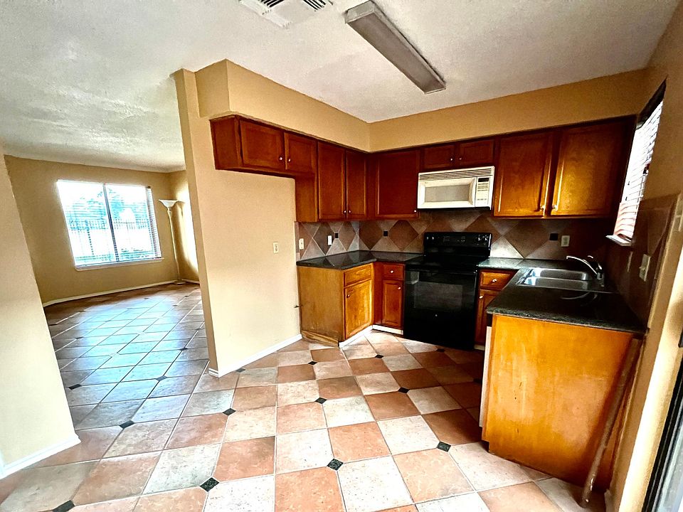 Kitchen with access to living room and garden atrium