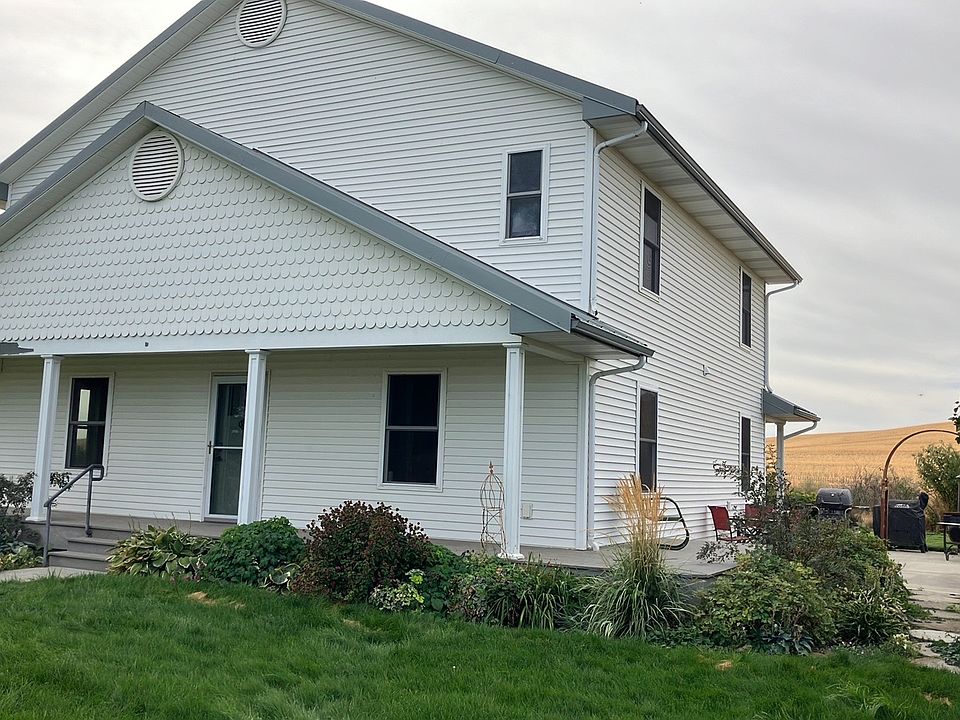 House with wrap around deck, patio on right side with access from rear door.