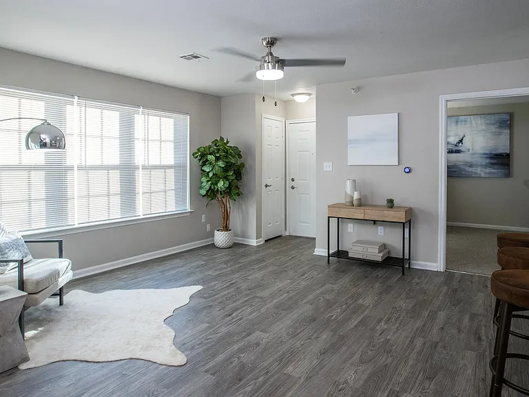 Our inviting living room boasts large, picturesque windows that usher in abundant natural light, infusing life and vibrancy into your space. Whether you seek relaxation, productivity, or entertainment, this welcoming oasis is prepared for all your needs.