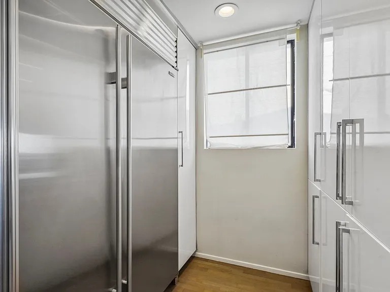 Fully equipped with top-of-the-line appliances, including a refrigerator, oven, and microwave.