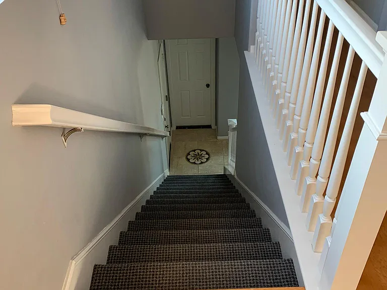 looking down stairs. 1st floor powder room straight ahead.
