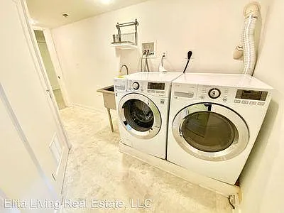 Laundry room with newer appliances.