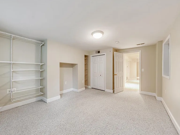 Bedroom with ample closet, plus additional Elfa shelves.