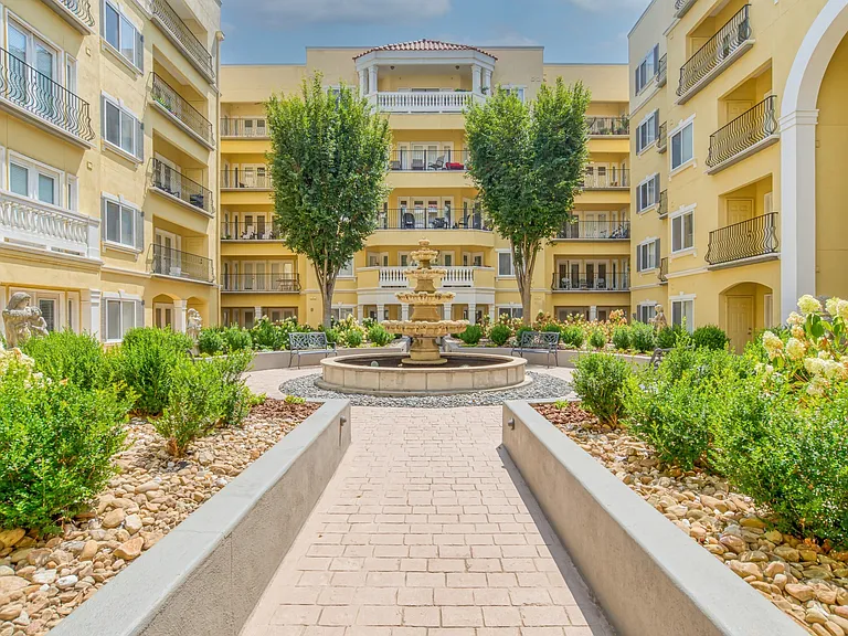 Tranquil courtyard with a fountain and luxurious landscaping
