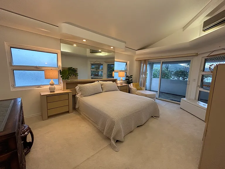 Primary bdrm with high ceilings, soffit lighting & balcony looking out to Lake