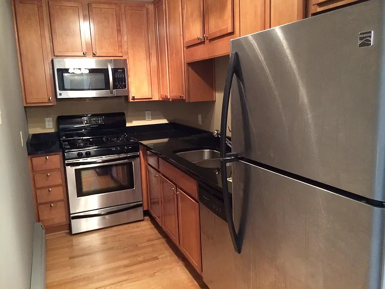 Kitchen with dishwasher, full sized fridge, microwave