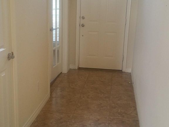 Entry hall with coat closet. Tile throughout the house.
