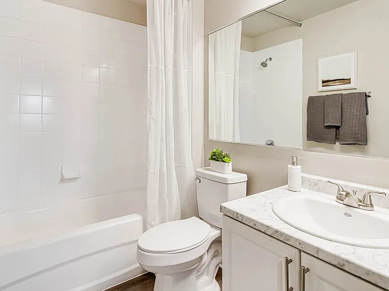 Spacious master bath boasting ample storage space and brilliant oversized mirrors.