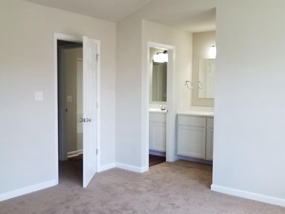 Master bedroom with ceiling fan,.  New carpet