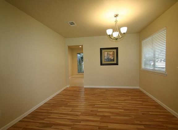 Formal dining with same honey maple flooring as living room and