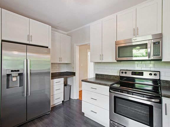 White kitchen with stainless appliances