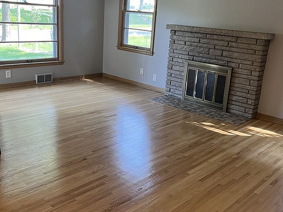 Sunny living room with fireplace.