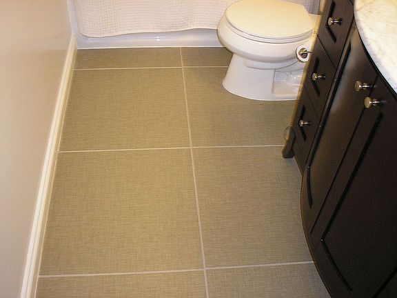 Nice large tile on bathroom floor.  Heated