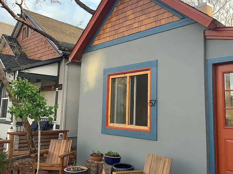 Front porch with Adirondack chairs and pots for tenants plants