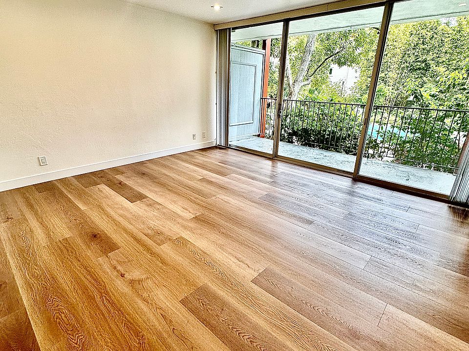 Unit #112 actual living room with modern can lighting throughout and stunning luxury floors!