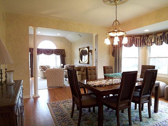 Dining Room with wood floors and bay window