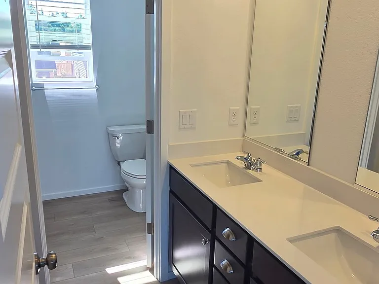 Master Bath with two sinks, walk-in closet and walk-in shower.