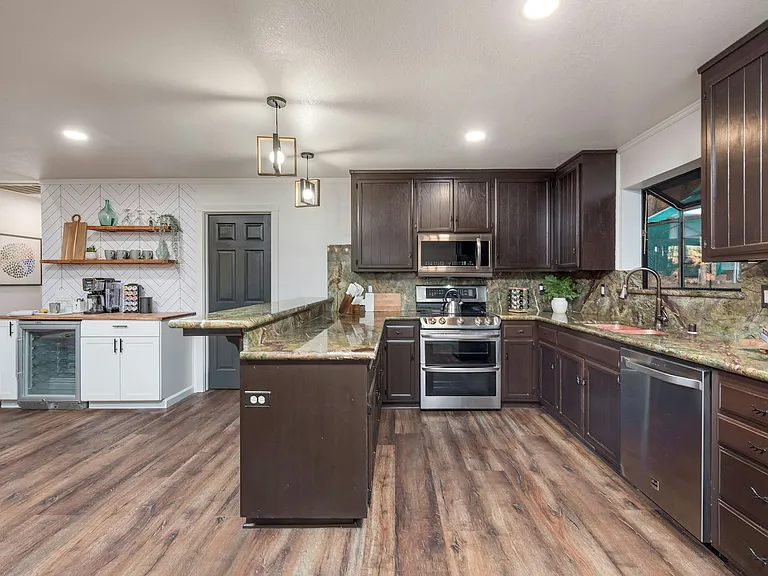 Spacious kitchen with lots of storage, granite countertops, copper sink.
