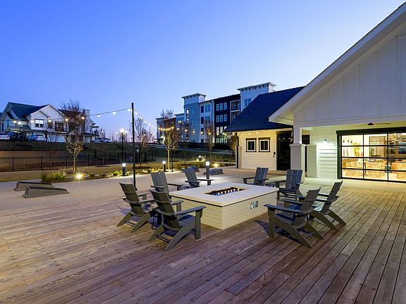 Outdoor lounge with fire pit and gaming lawn