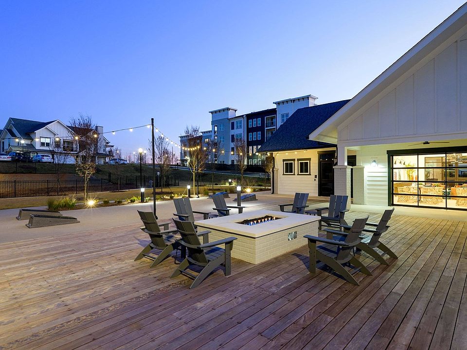 Outdoor lounge with fire pit and gaming lawn