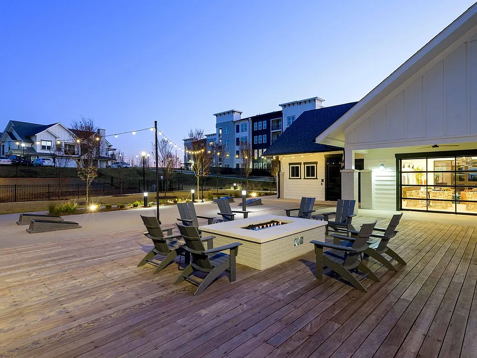 Outdoor lounge with fire pit and gaming lawn