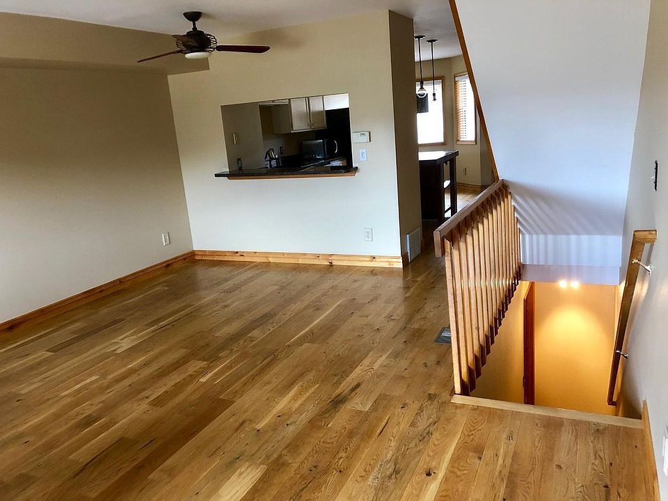 Balcony looking back into living room through kitchen. Stairs from mud room level to main floor
