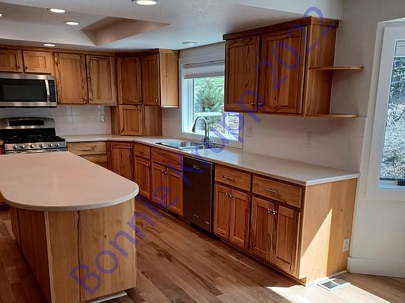 Kitchen includes dishwasher, Stove, Refrigerator and microwave.