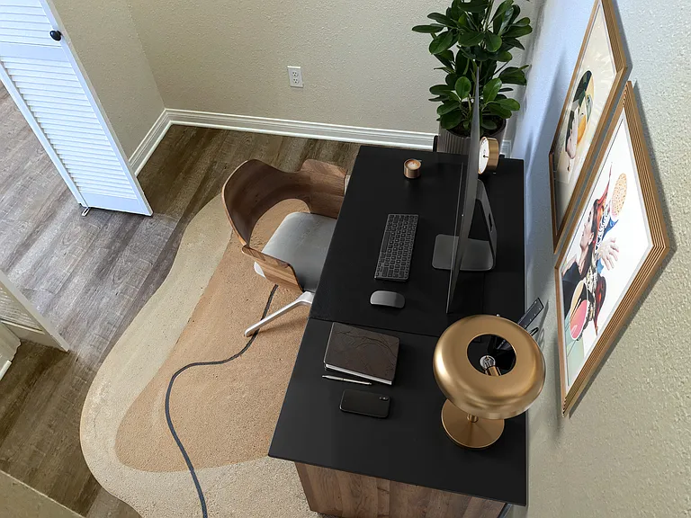 Small office or bedroom has closet with upper area storage and ceiling fan with LED light.