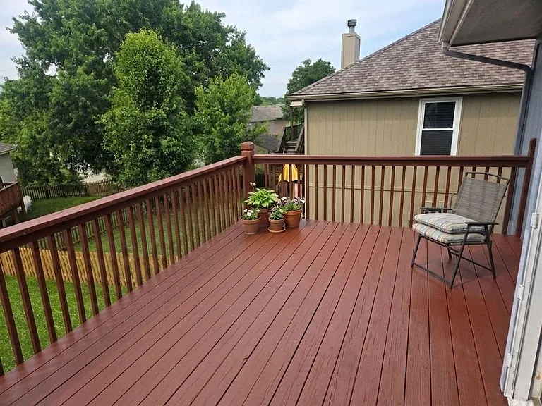 Spacious elevated deck and open viewsideal for outdoor dining, and relaxing, overlooking a private, tree-lined yard.
