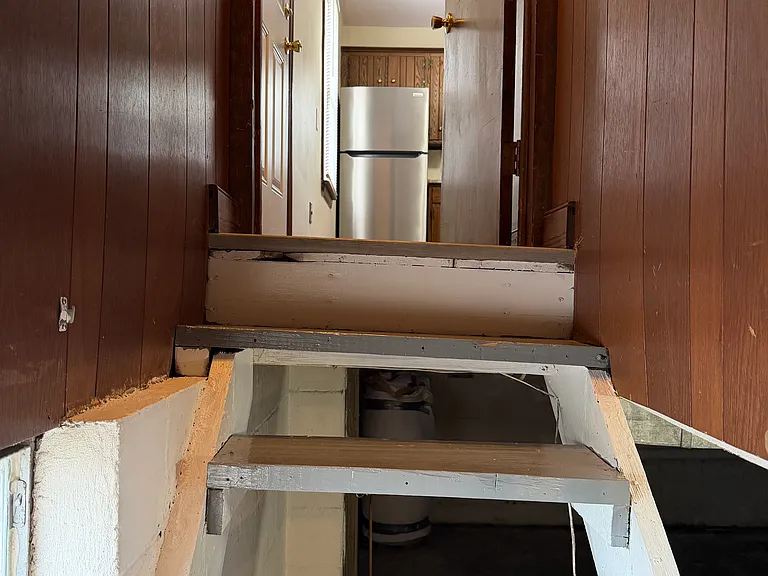 View of kitchen from basement steps.