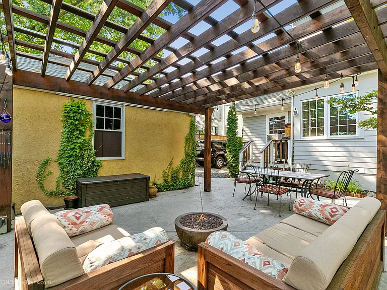 Outdoor furniture, speaker system and pull down screen for outdoor movies! Concrete patio with gas fire pit will make hanging outside this Summer even more enjoyable!