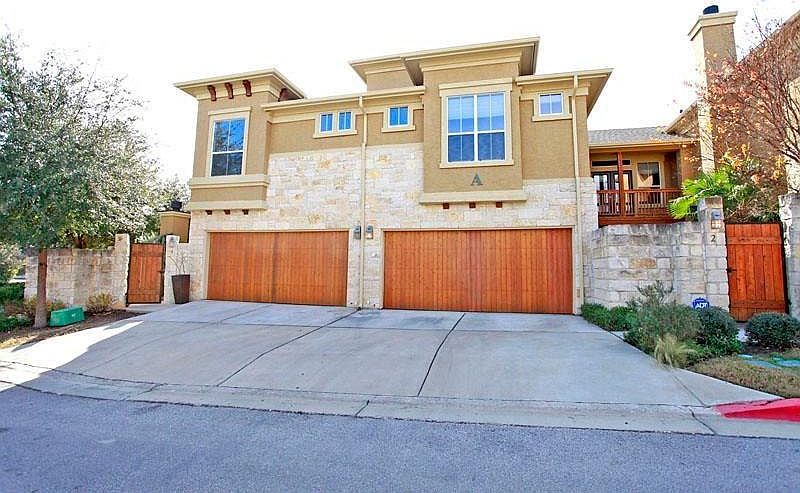 FRONT VIEW OF 2 CAR GARAGE AND PRIVATE COURTYARD
