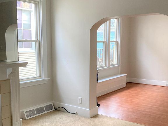 Arched doorway opens living room to dining room