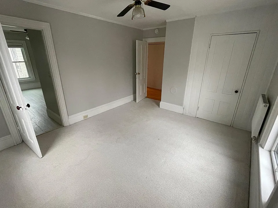 Front bedroom which is carpeted.